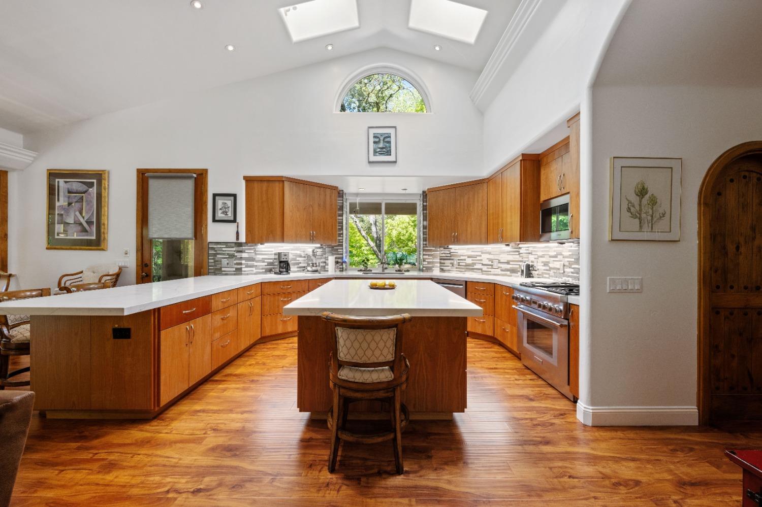 Newly renovated kitchen is well appointed with quartz countertops, new high-end stainless steel appliances, wood cabinetry and new laminate wood flooring. Not shown are the new refrigerator and walk in pantry.