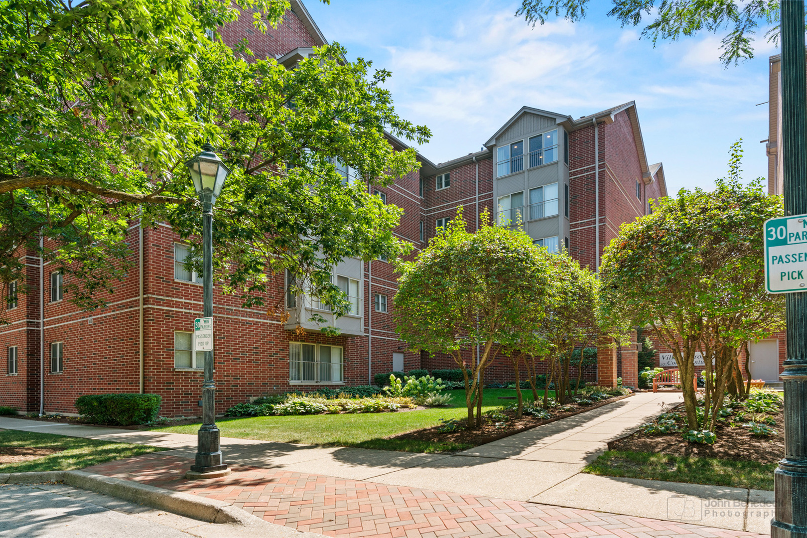 a view of a brick building next to a yard