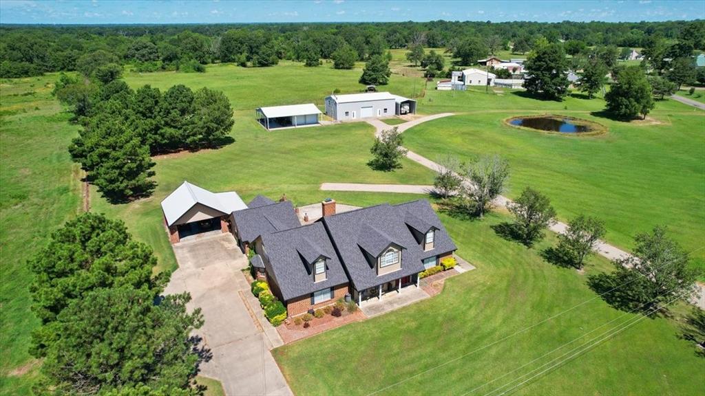 an aerial view of a house with outdoor space pool patio and yard