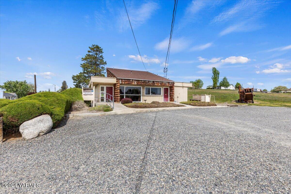 a view of a house with a yard and a garage