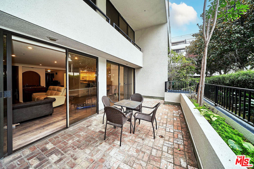 a view of a patio with a table and chairs