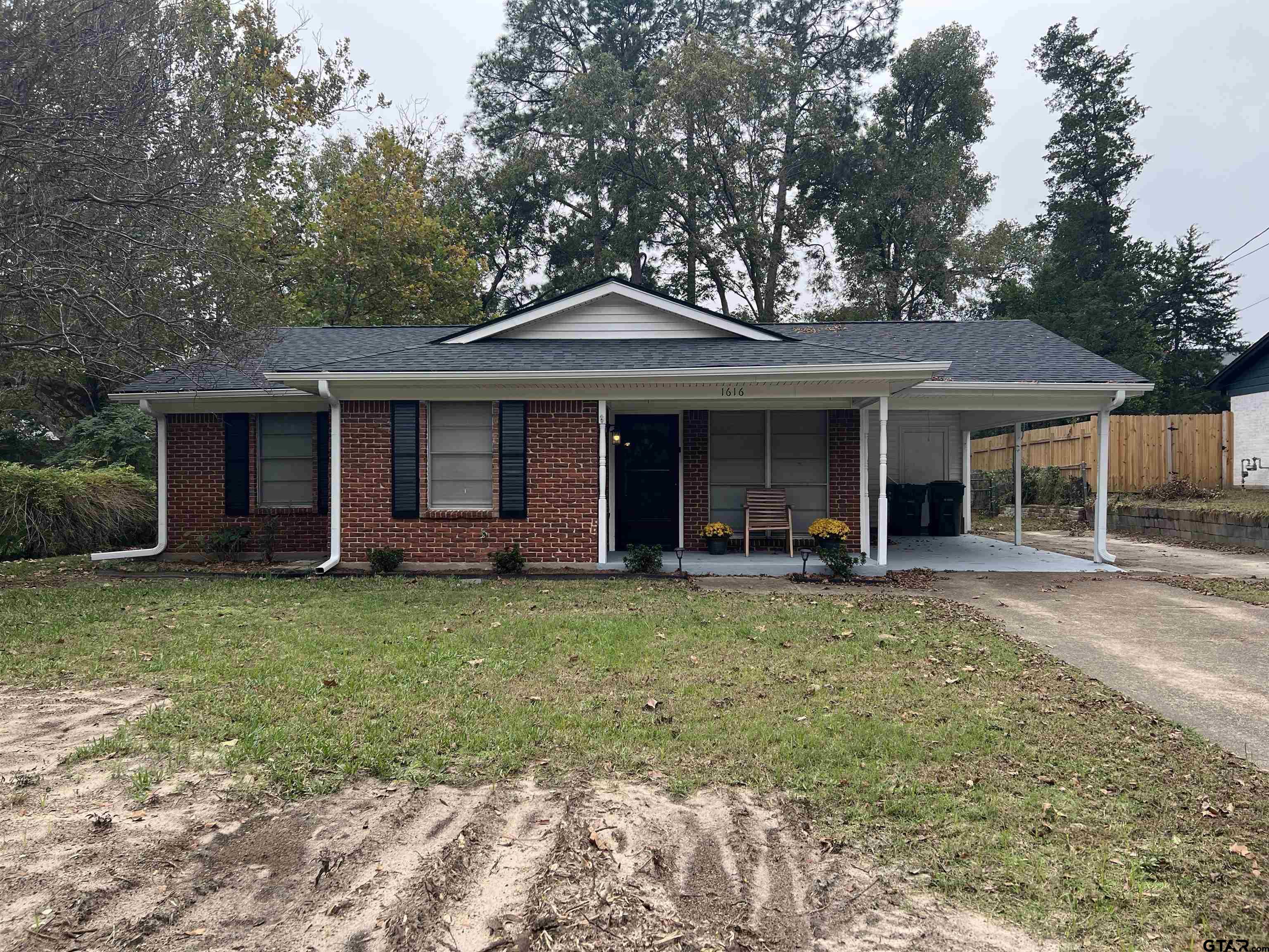 a front view of a house with a yard and porch