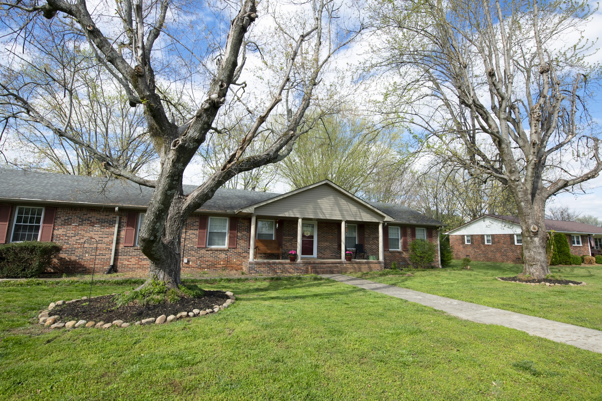 a front view of a house with a garden