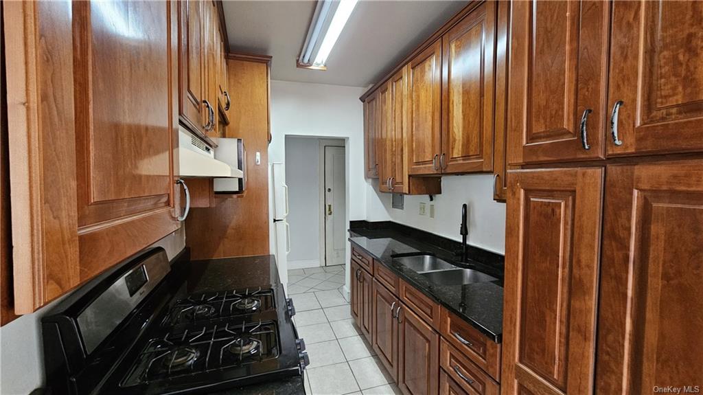 a kitchen with wooden cabinets and a stove top oven