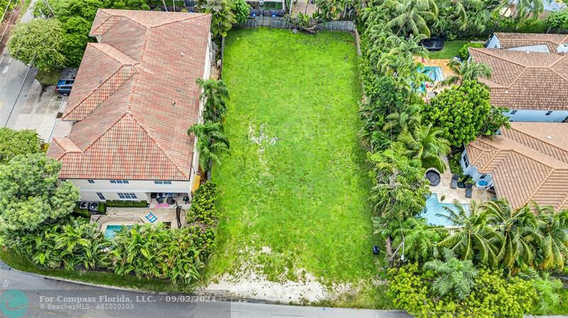 a aerial view of a house with a yard and garden