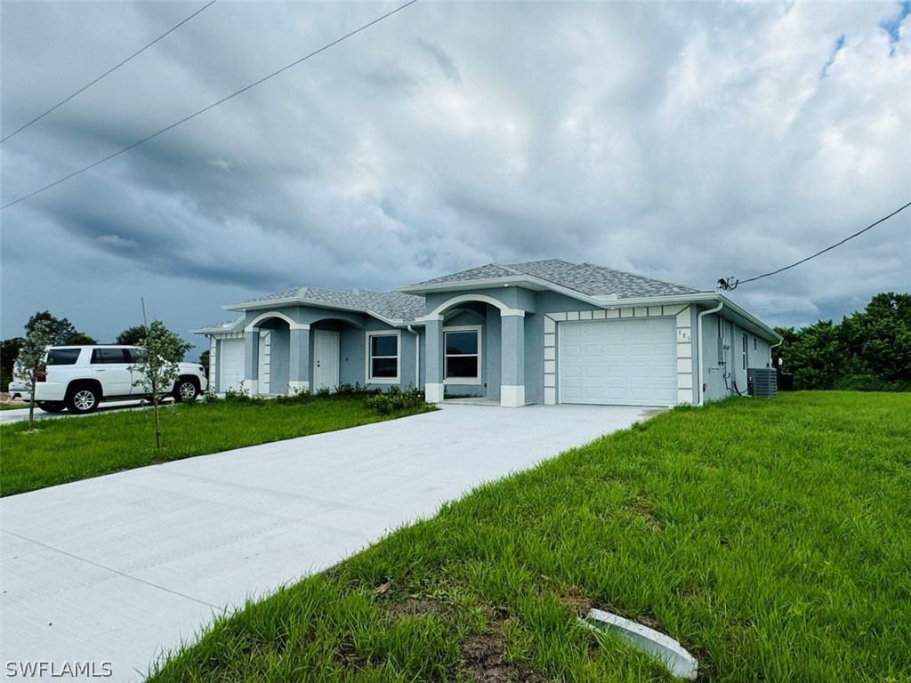 a front view of house with yard and green space