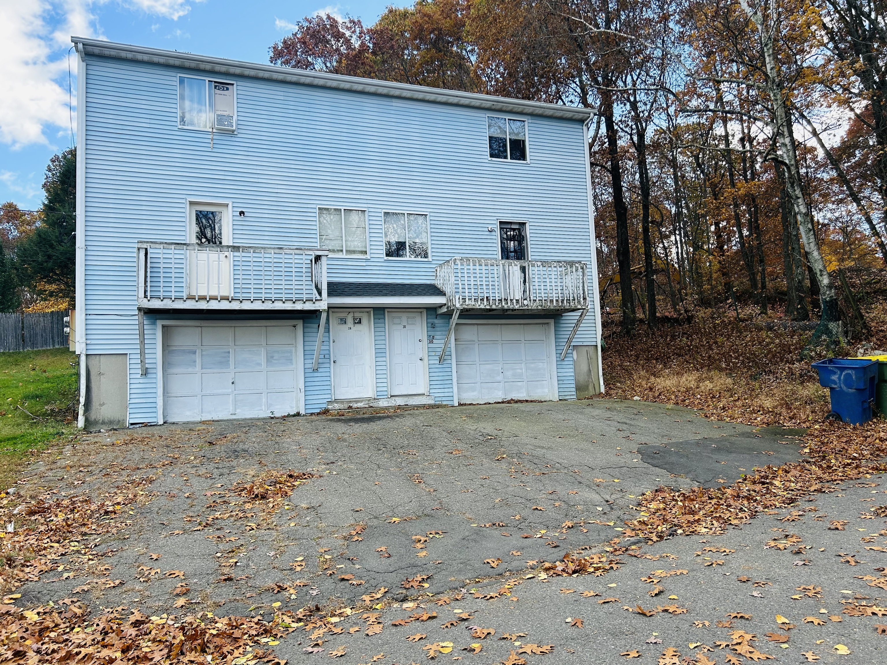 a view of a house with wooden fence