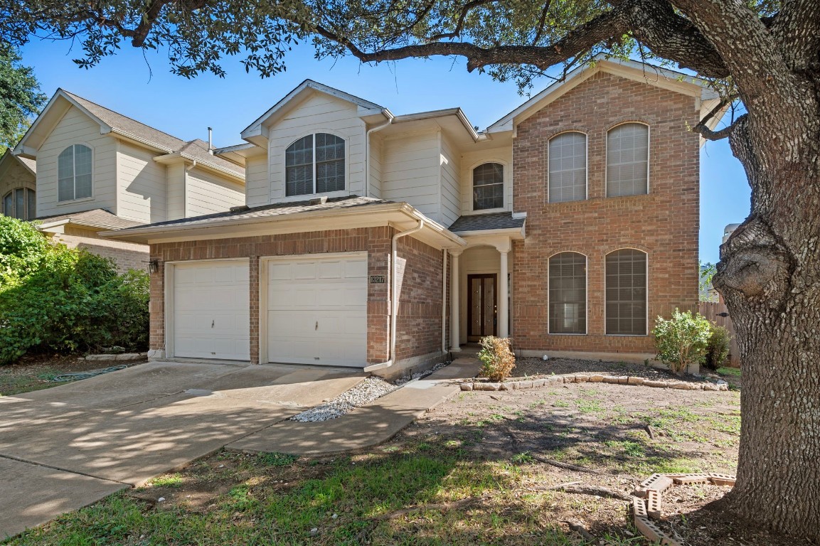 a front view of a house with a yard and garage