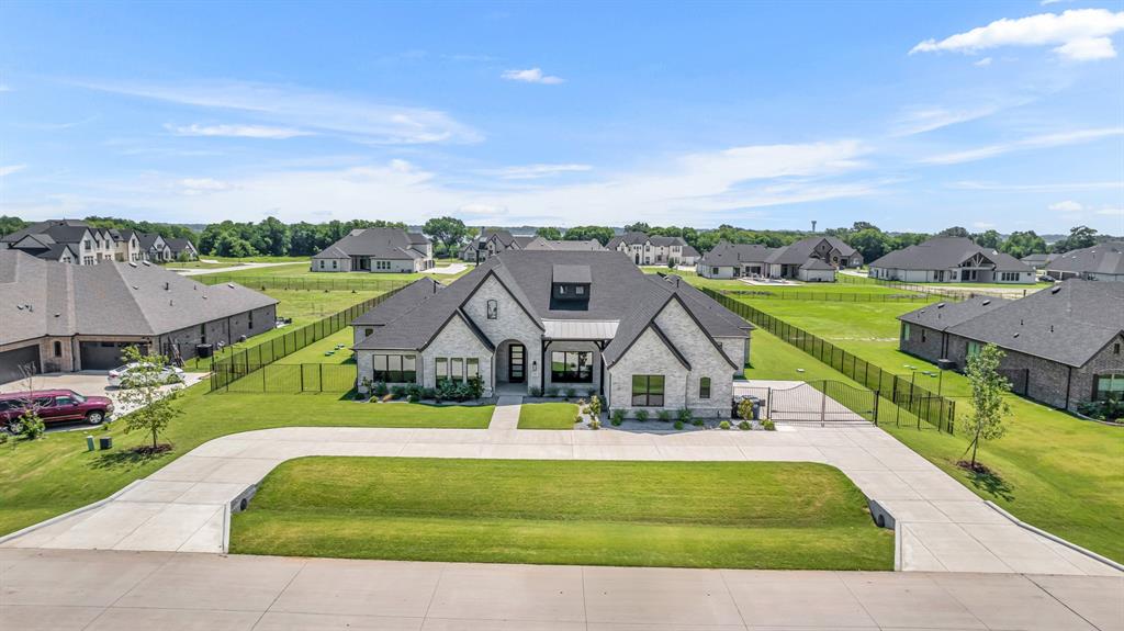 an aerial view of a house with a big yard