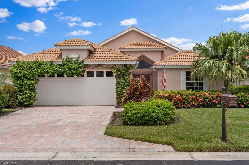 Mediterranean / spanish-style house with a front yard and a garage