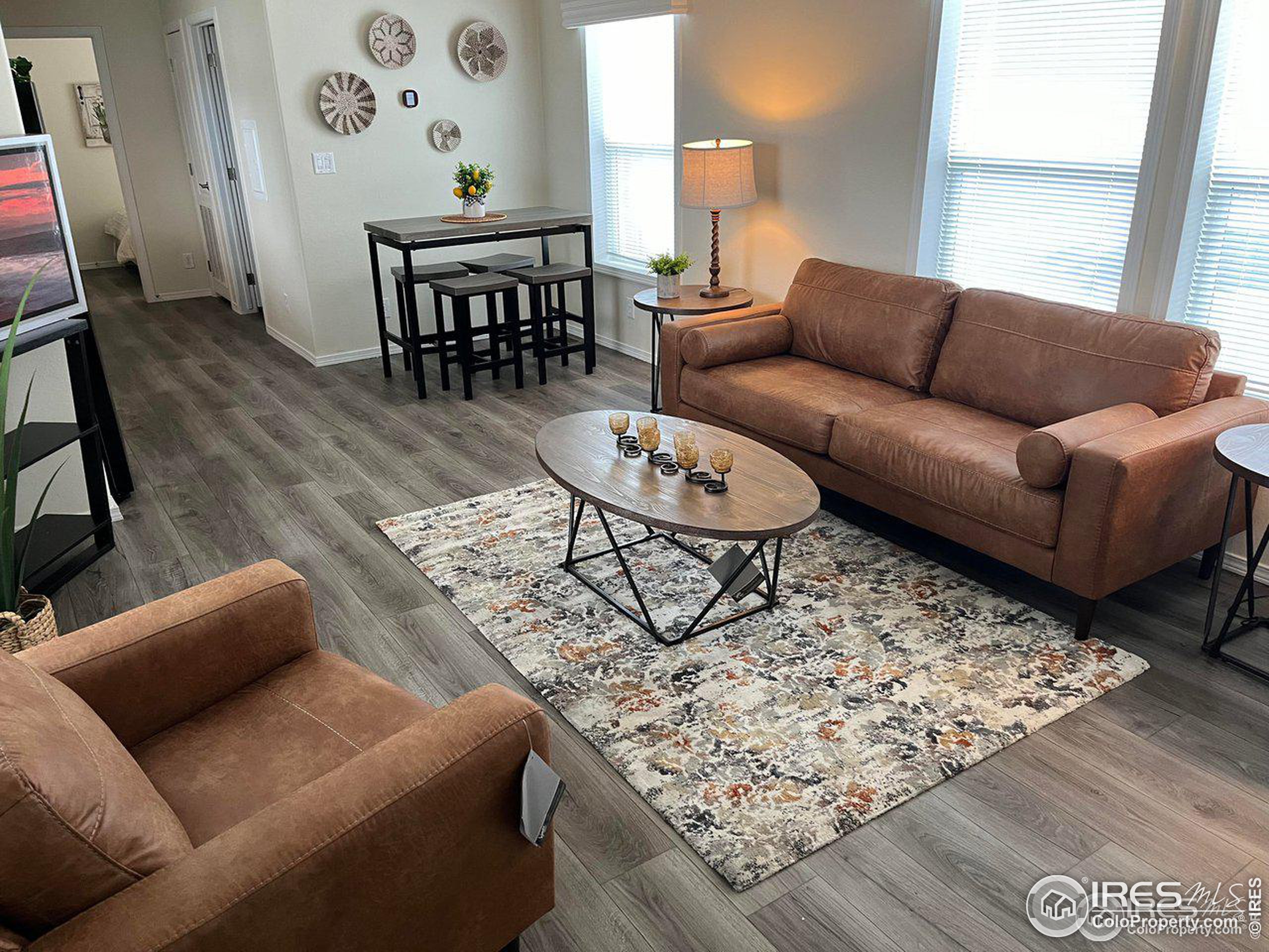 a living room with furniture and wooden floor