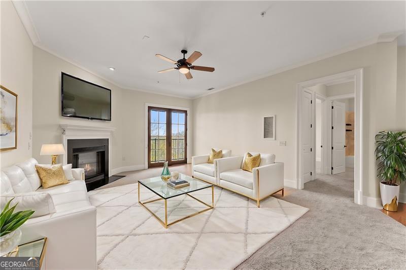 a living room with furniture a fireplace and a flat screen tv