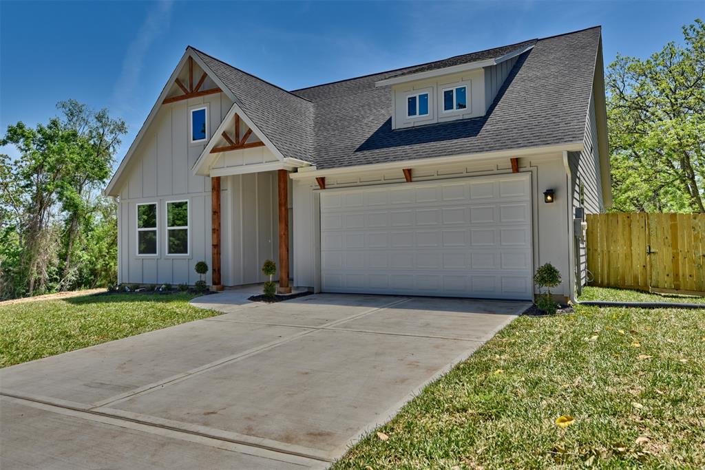 a view of a house with a yard and garage