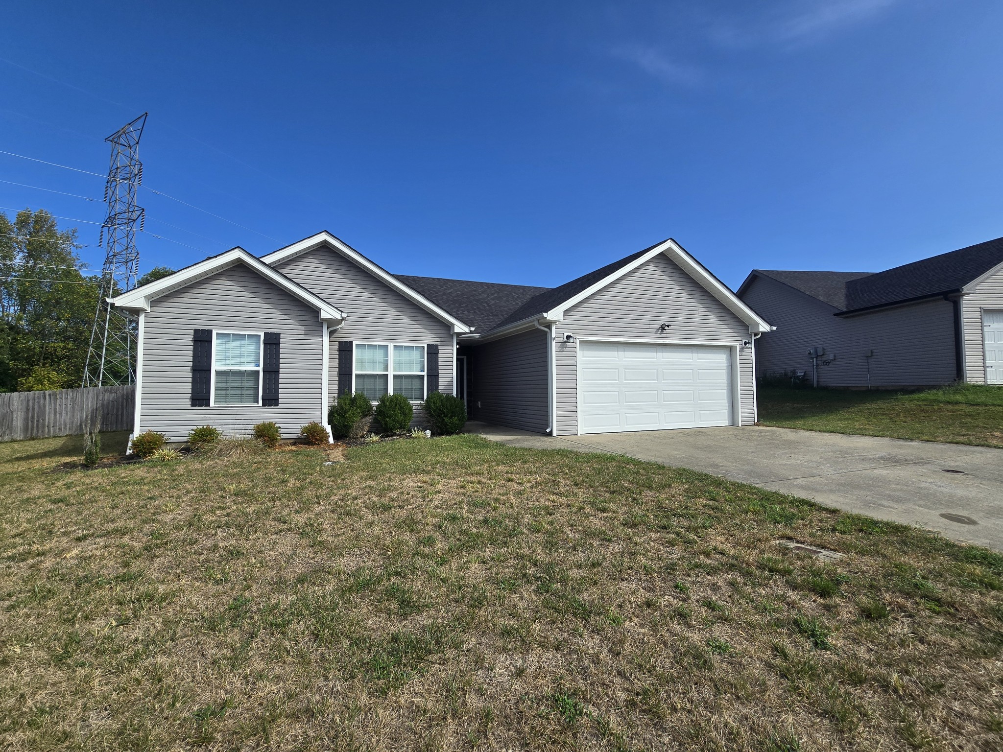 a view of a house with a yard and garage