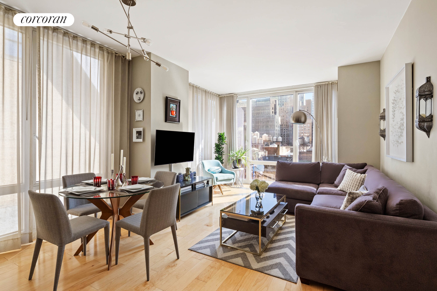 a living room with furniture a large window and a flat screen tv