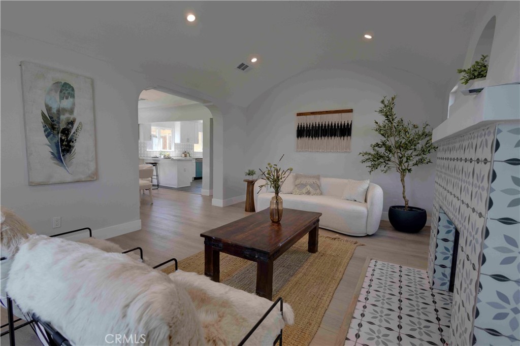 a living room with furniture and a potted plant