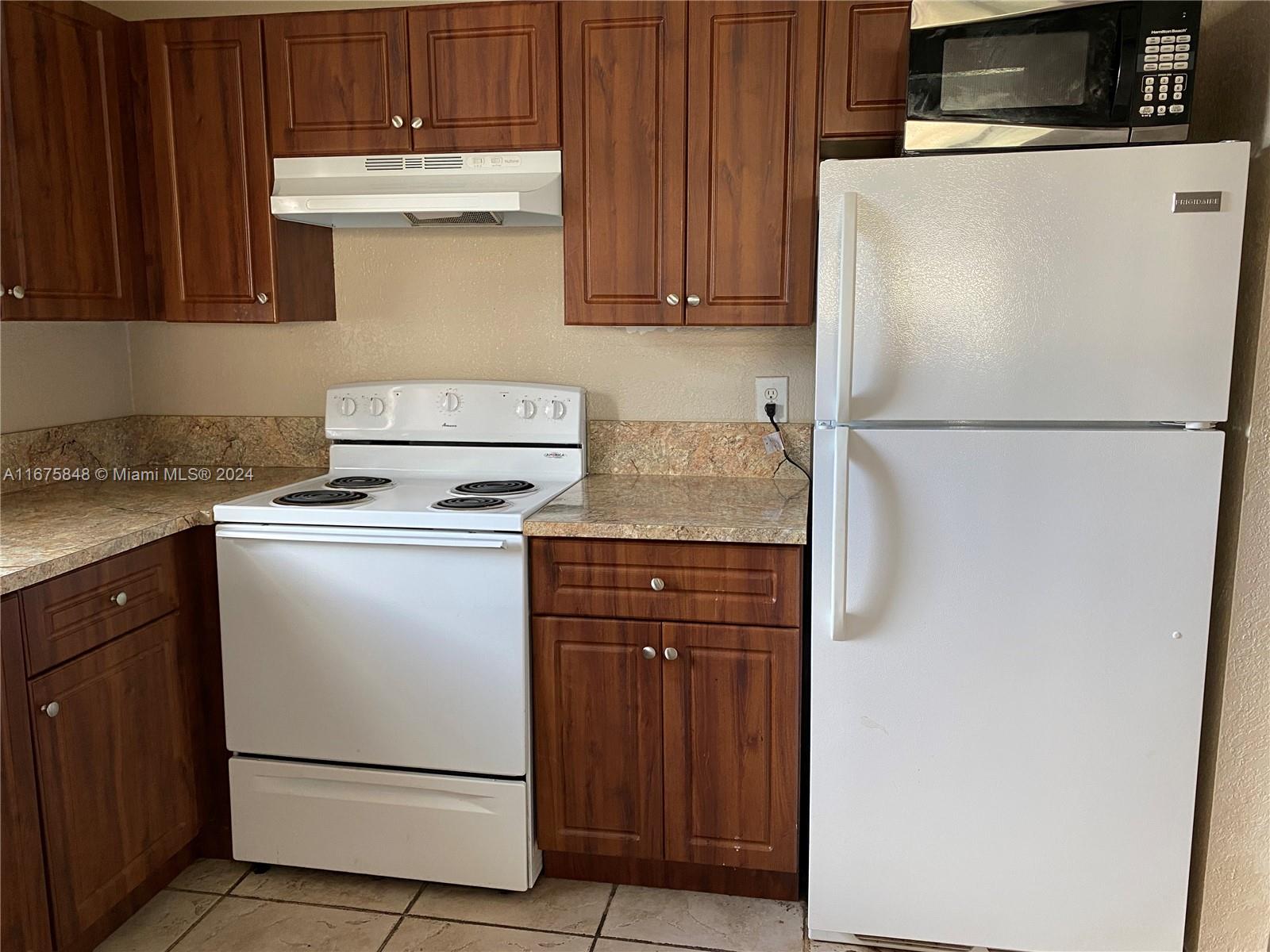 a white refrigerator freezer sitting inside of a kitchen