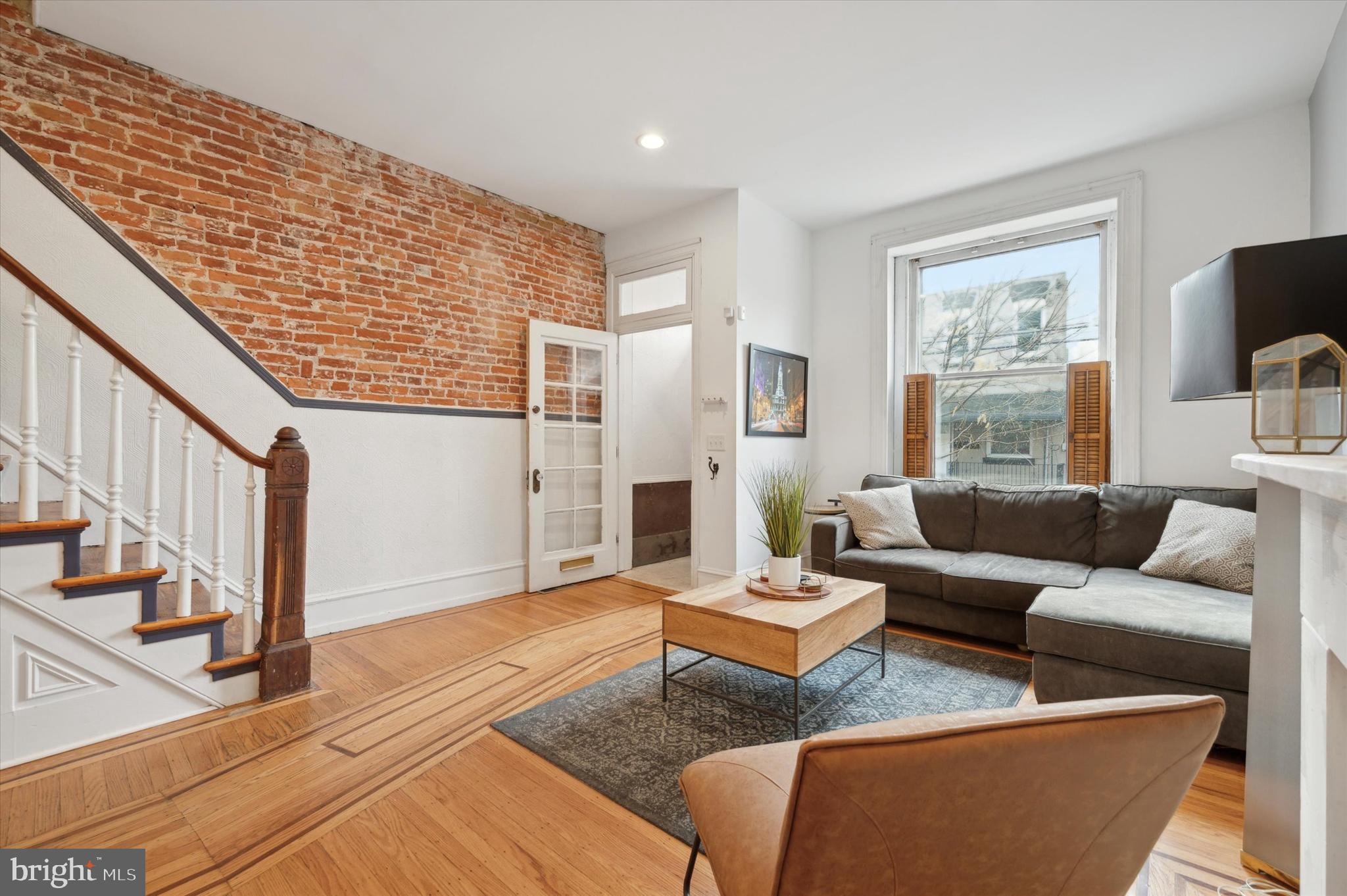 a living room with furniture floor to ceiling window and a flat screen tv