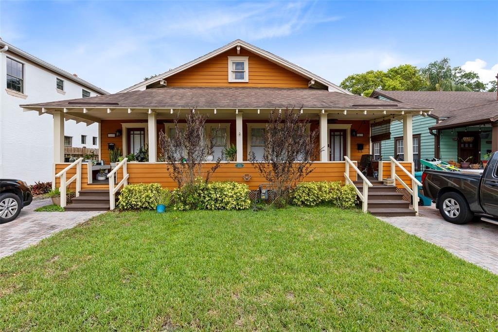 a view of a house with backyard porch and sitting area