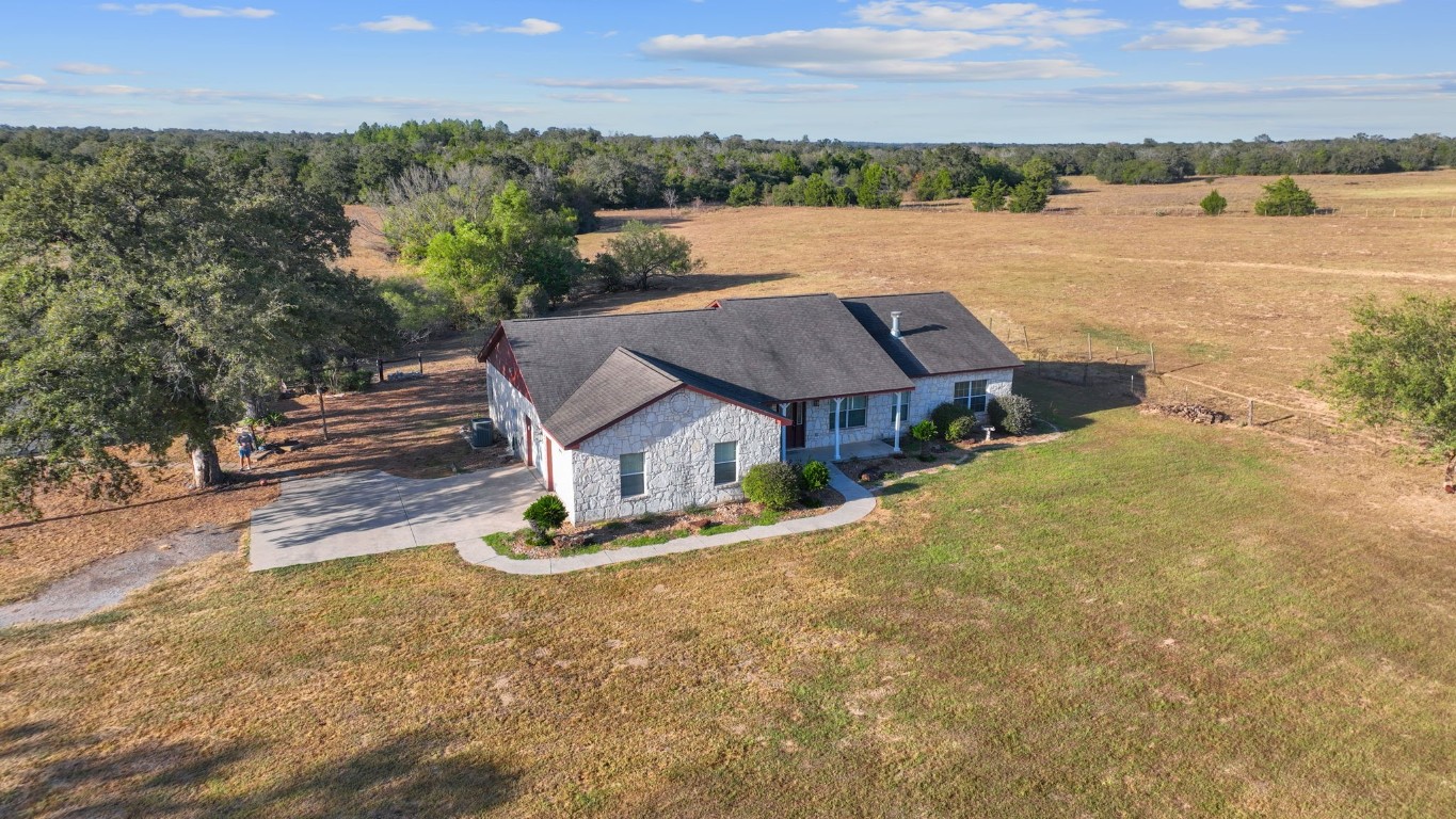 an aerial view of a house with outdoor space and lake view