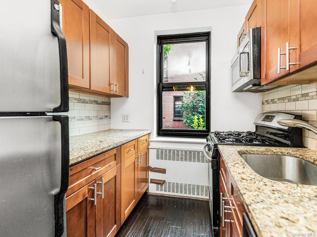 a kitchen with a refrigerator sink and cabinets