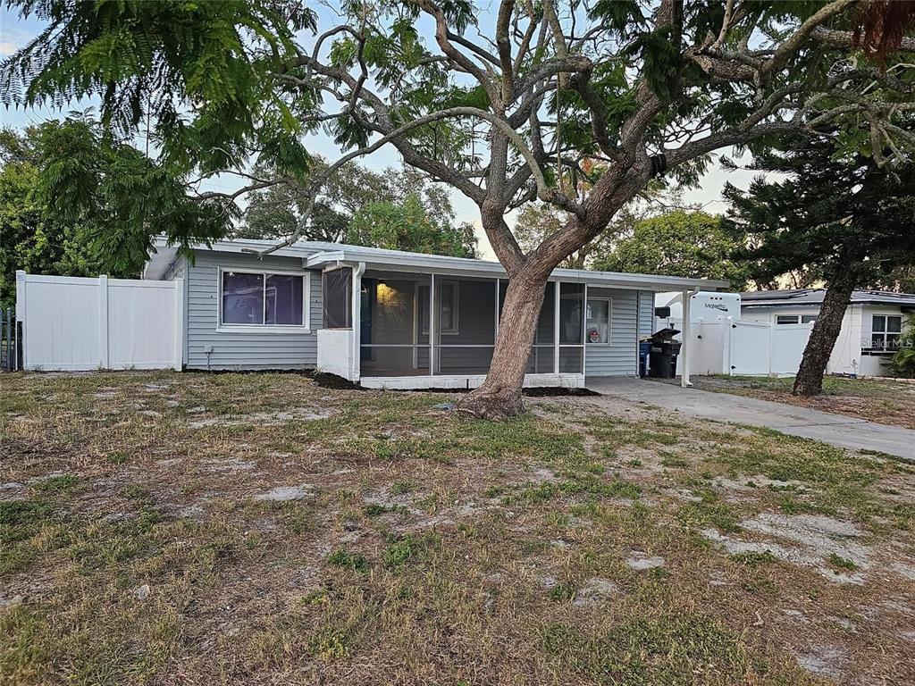 a front view of house with yard and trees