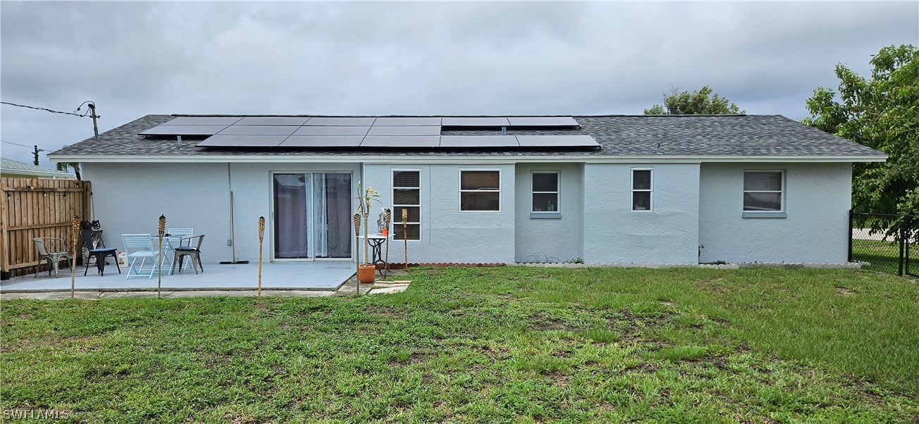 a view of a house with a yard and sitting area