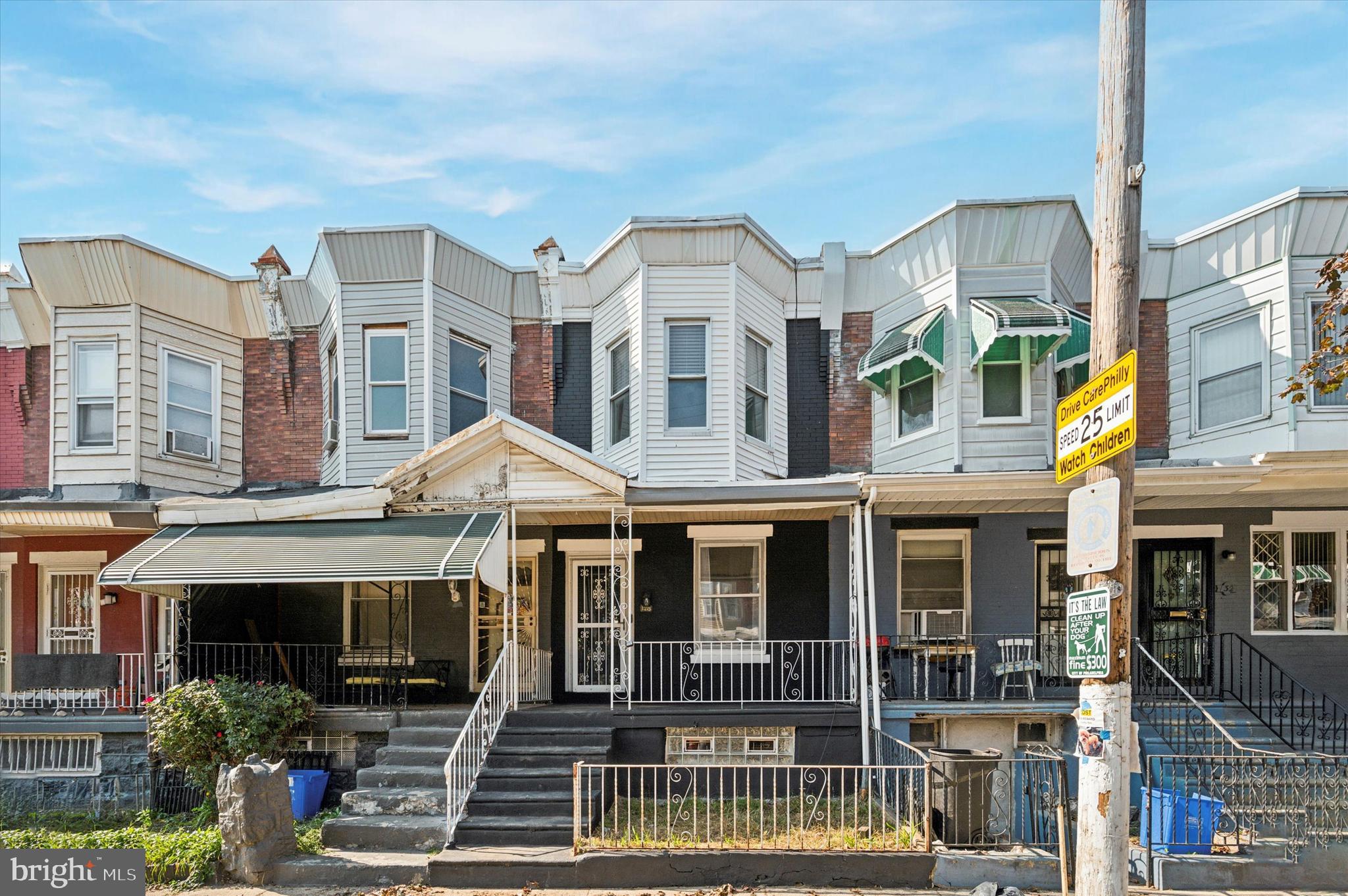 a front view of a residential apartment building with a yard