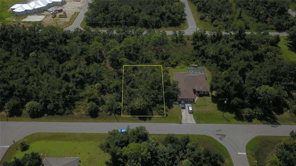 an aerial view of a house with a yard and lake view