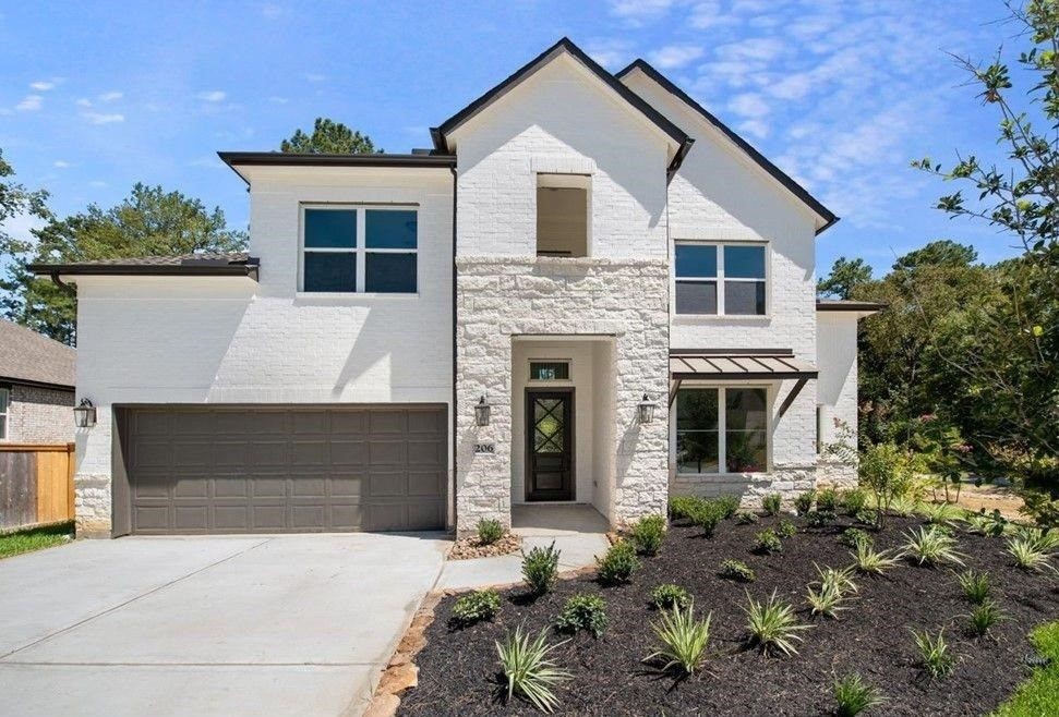 a front view of a house with a garden