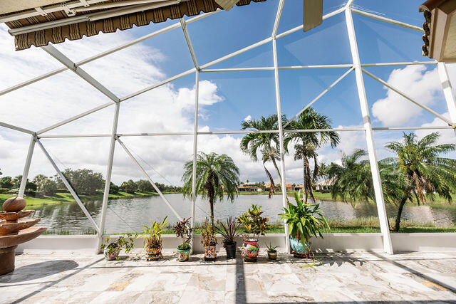 a group of palm trees in front of a room