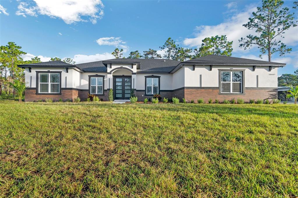 a front view of a house with a yard