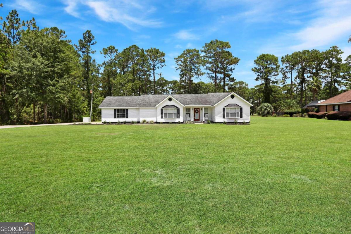 a view of a house with a yard