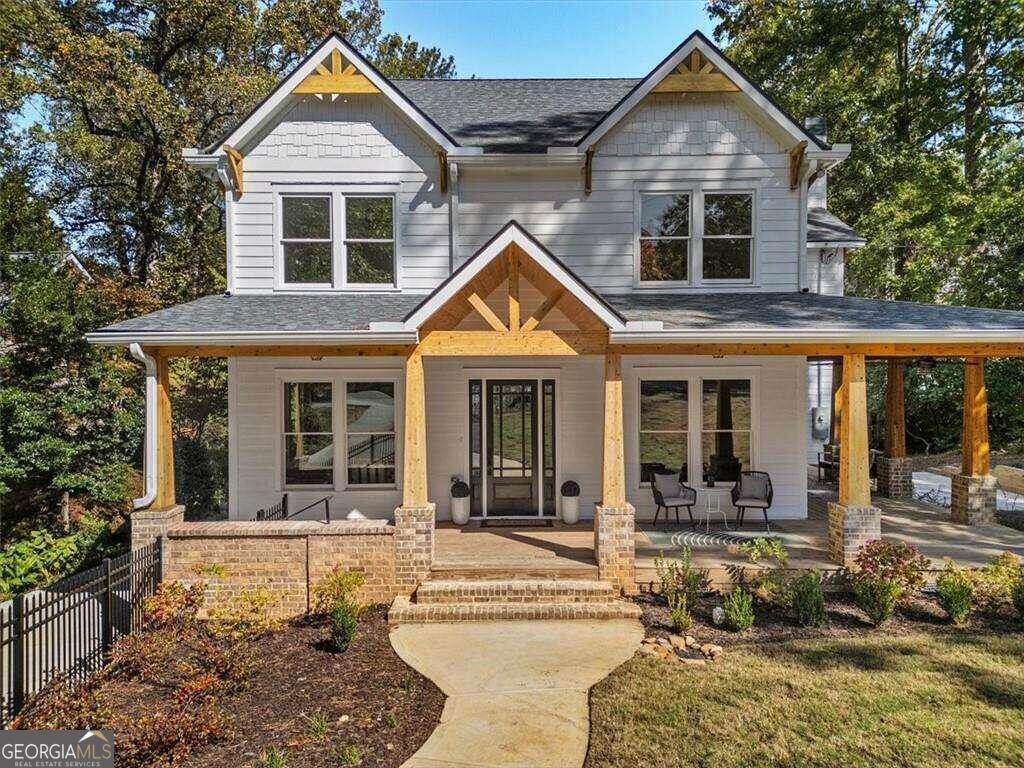 a front view of a house with a yard outdoor seating and garage