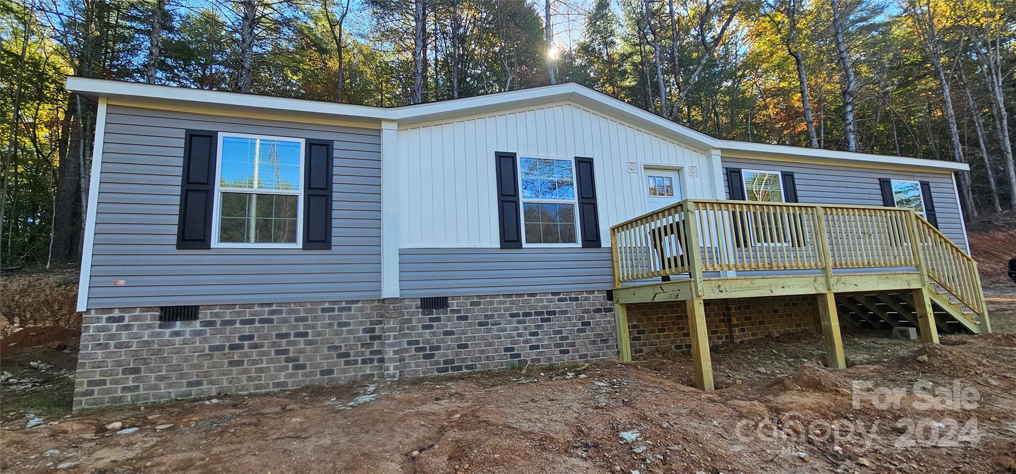 a view of house with a yard and deck