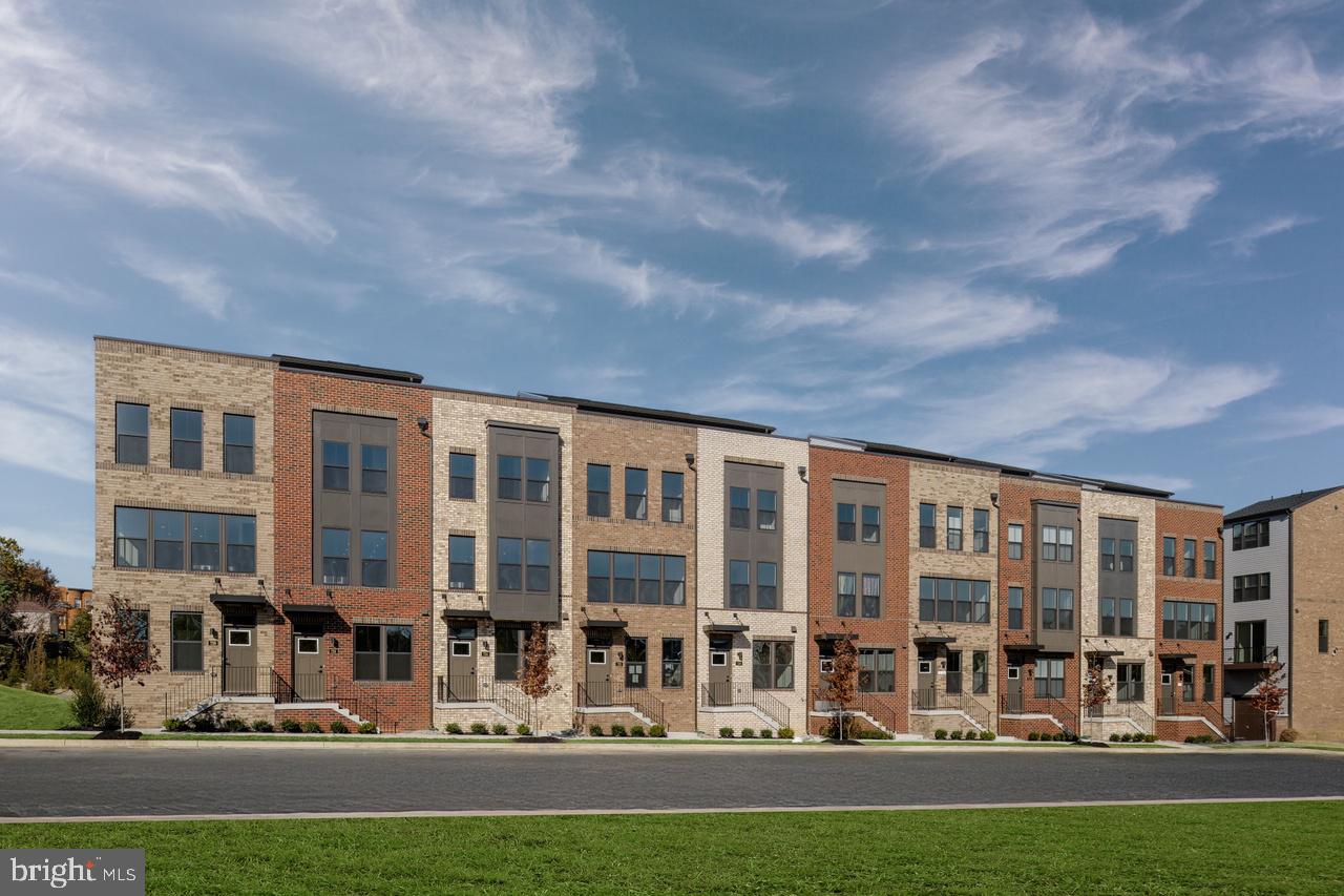 a front view of building with yard and outdoor seating