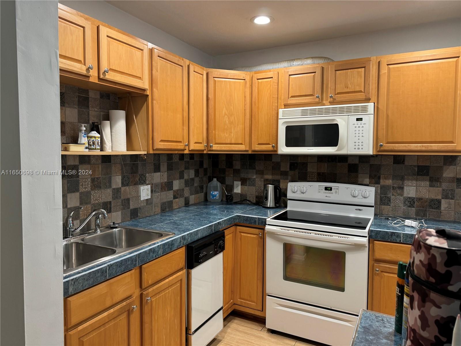 a kitchen with a sink stove and microwave