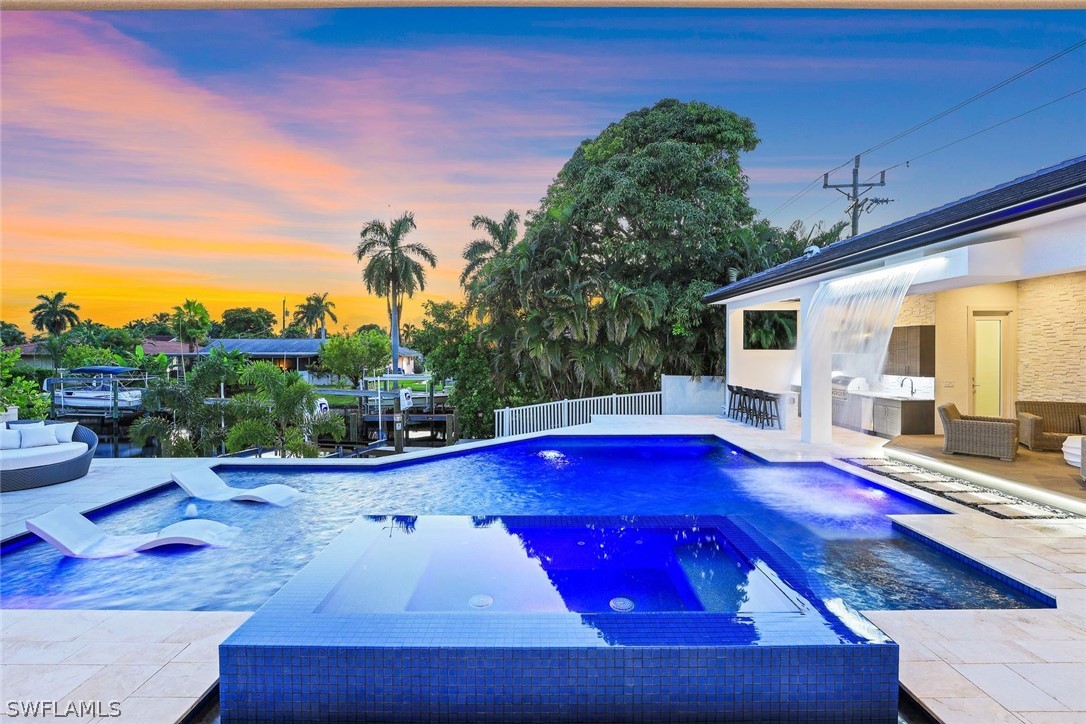 a view of swimming pool with chairs in patio