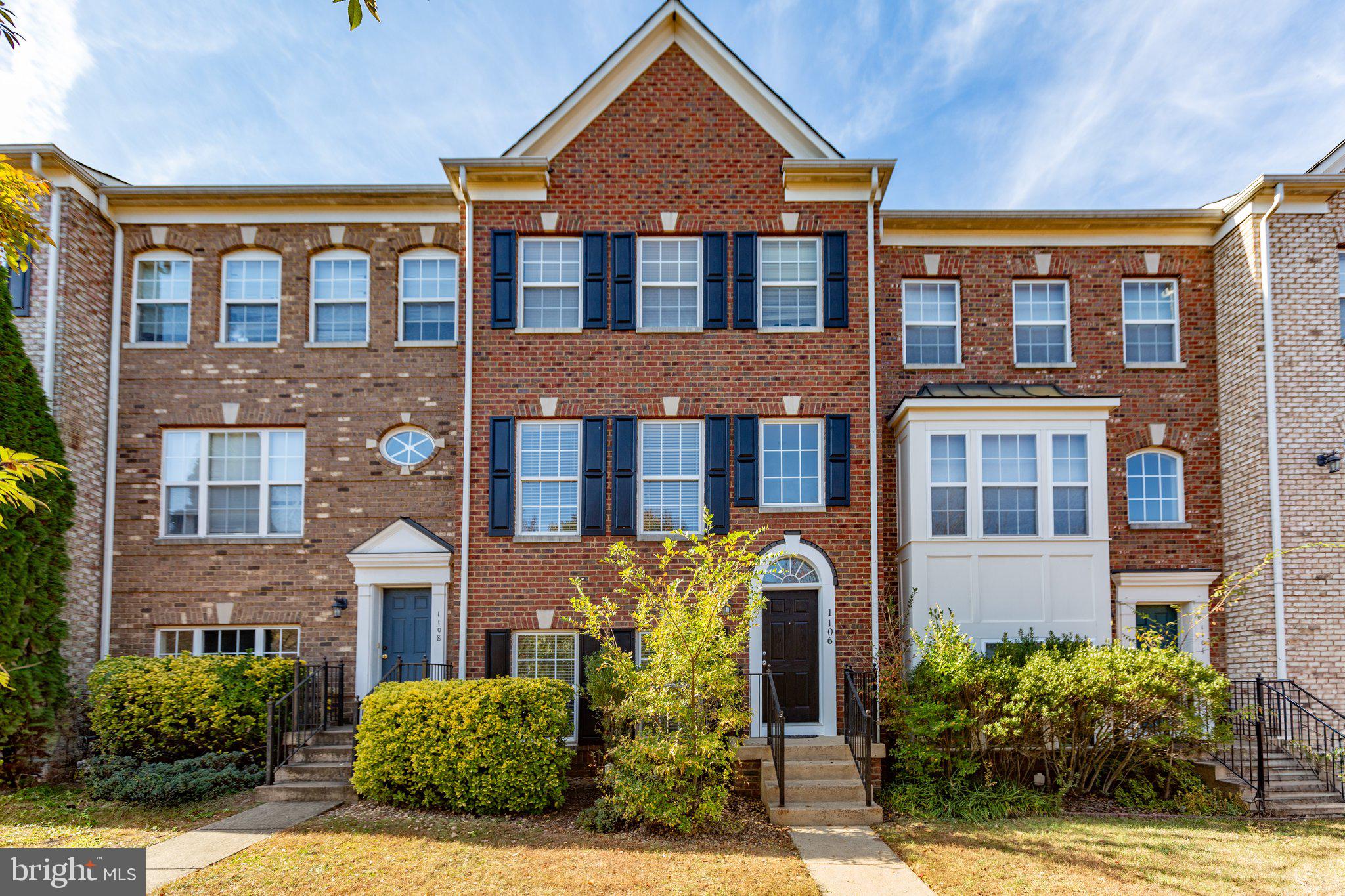 a front view of a residential apartment building with a yard