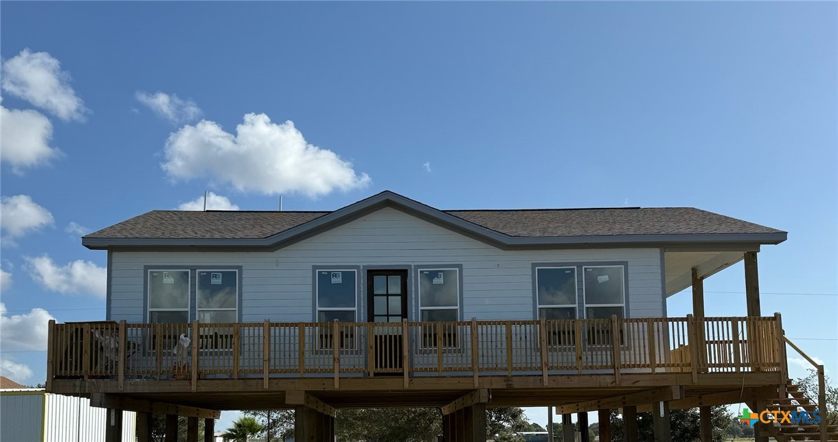 a view of house with outdoor space and sitting area