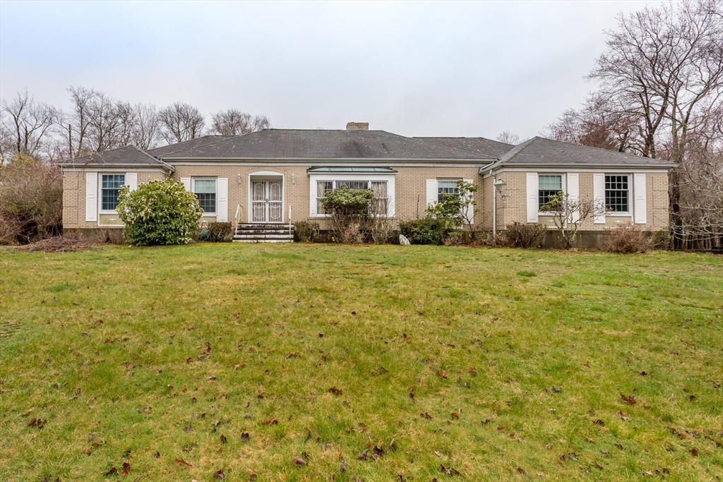 a front view of a house with a garden