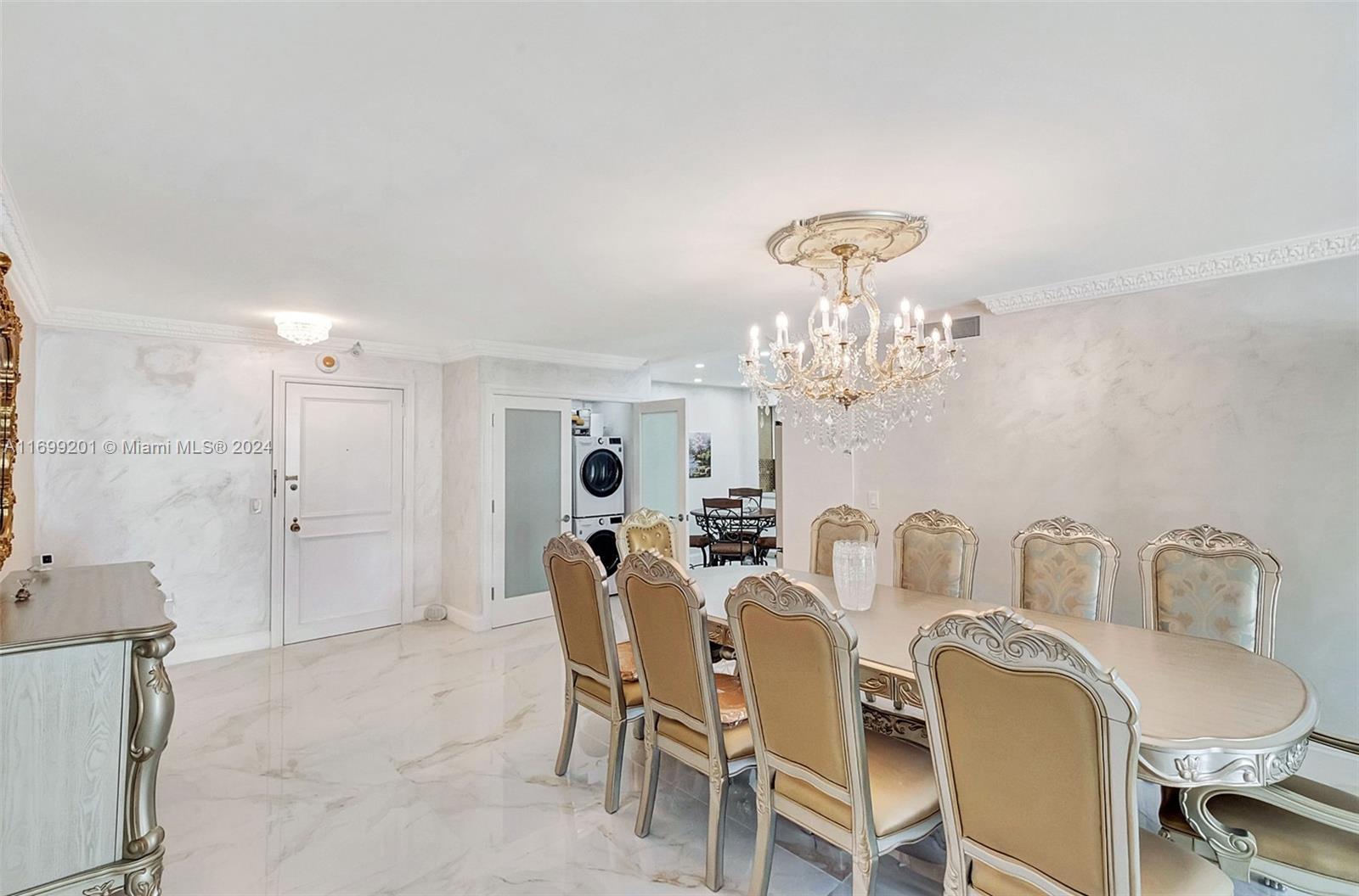 a dining room with furniture and chandelier