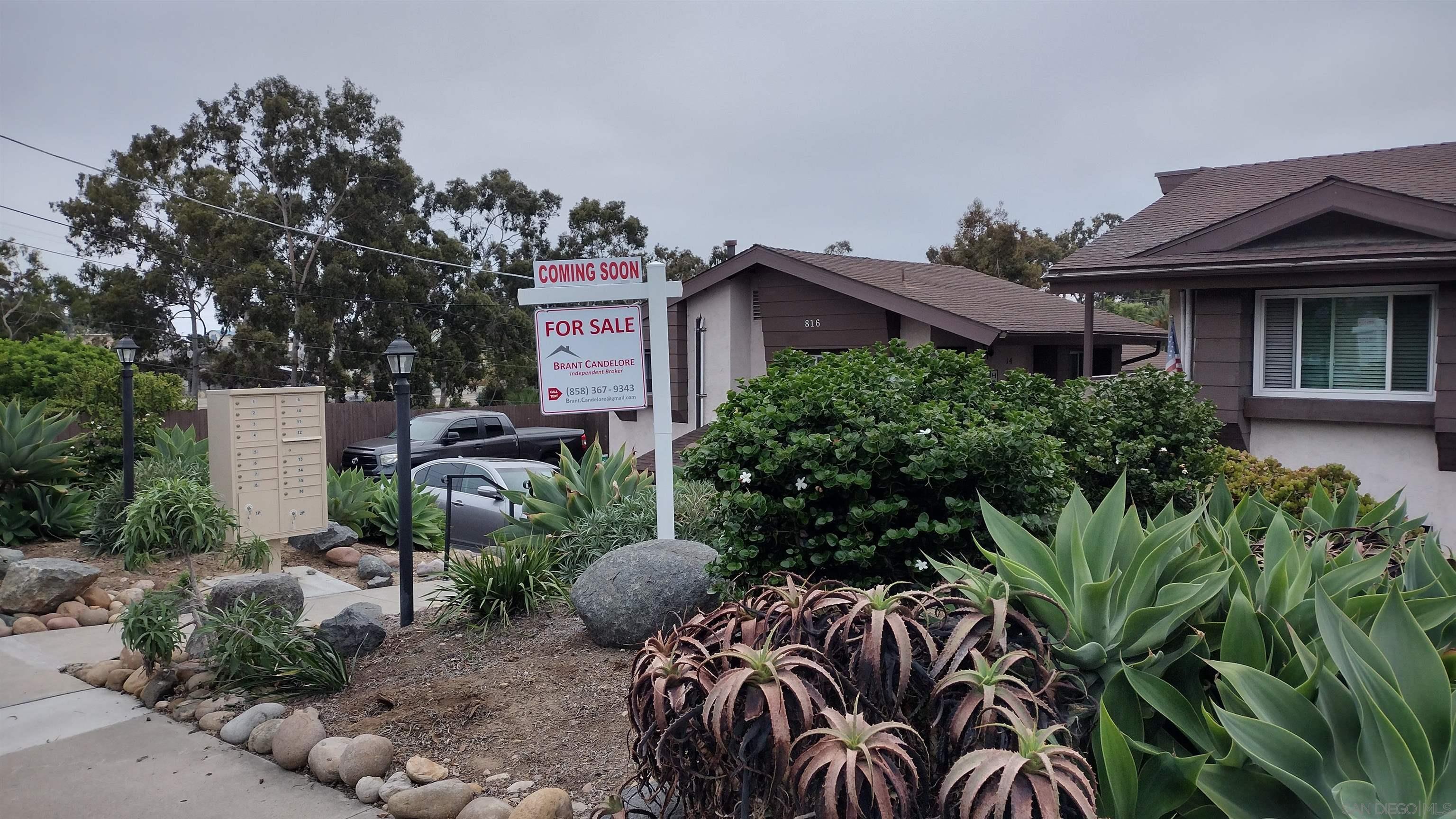 a view of a house with plants and a pathway