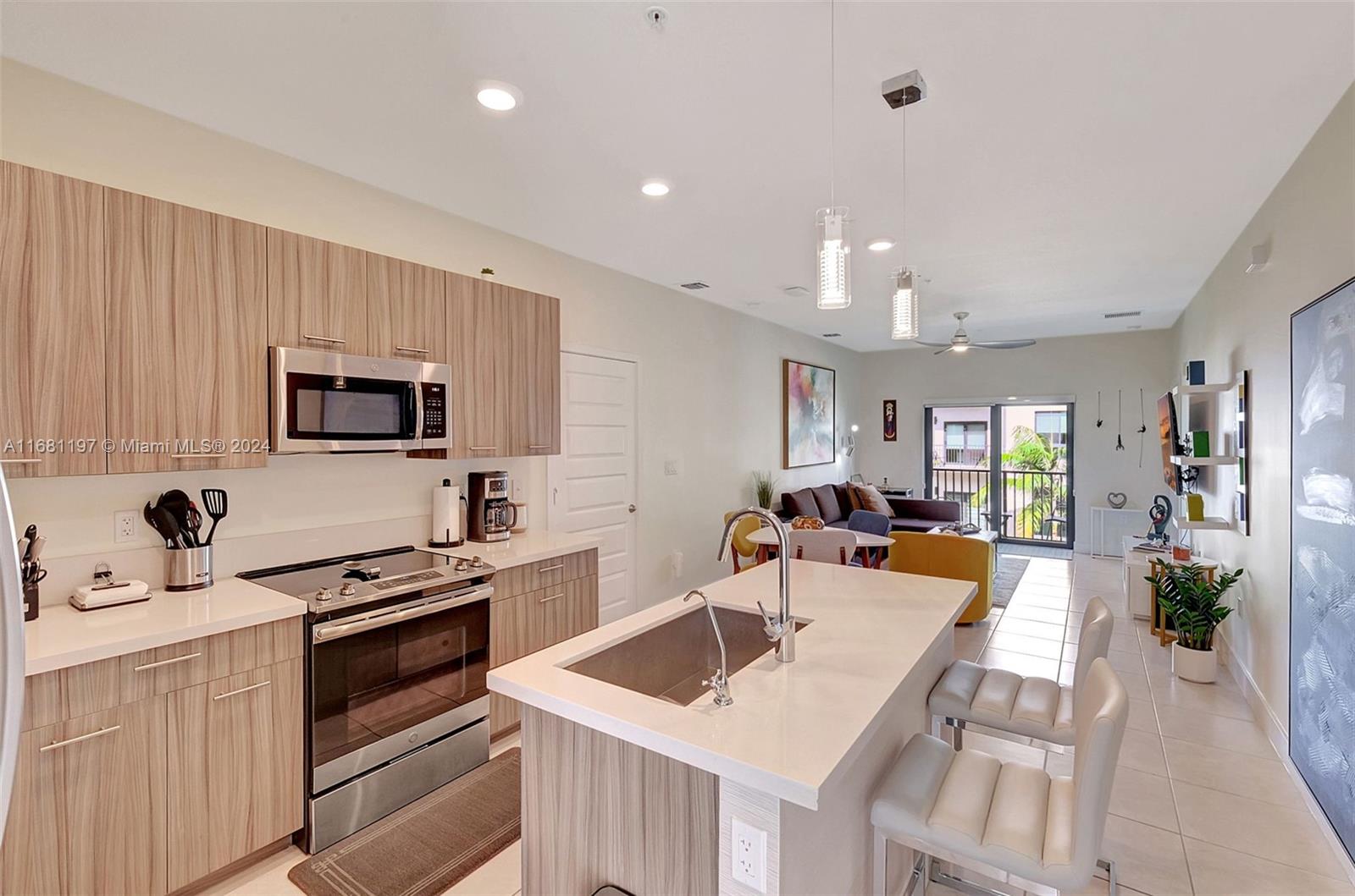 a kitchen with a sink a stove and chairs