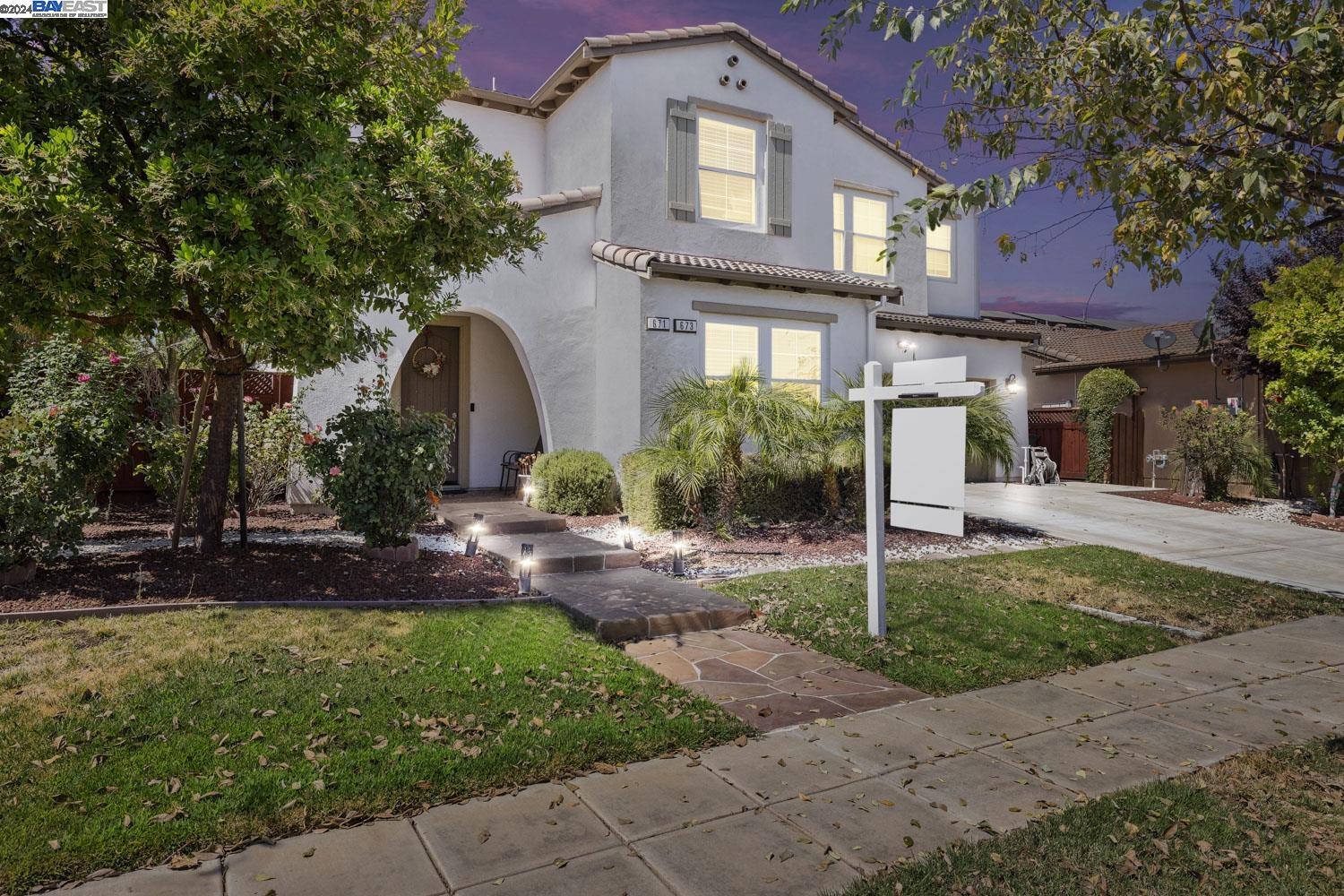 a front view of a house with a garden