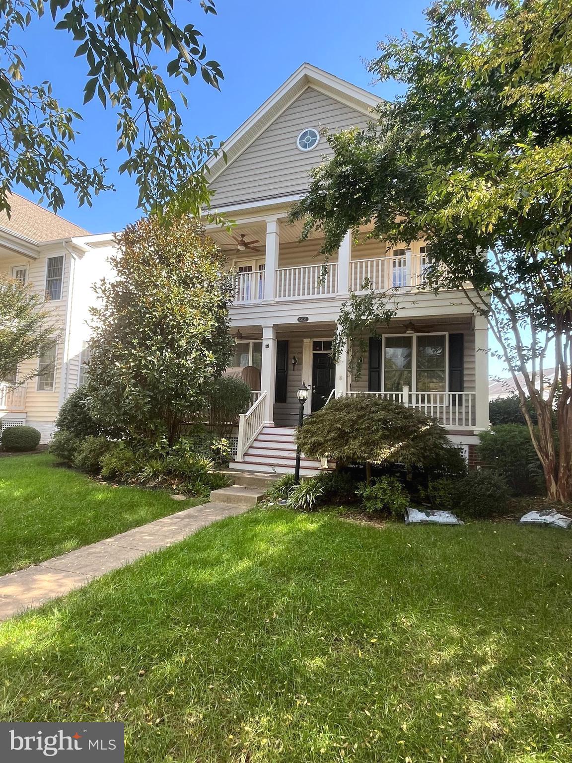 a front view of a house with a garden and yard