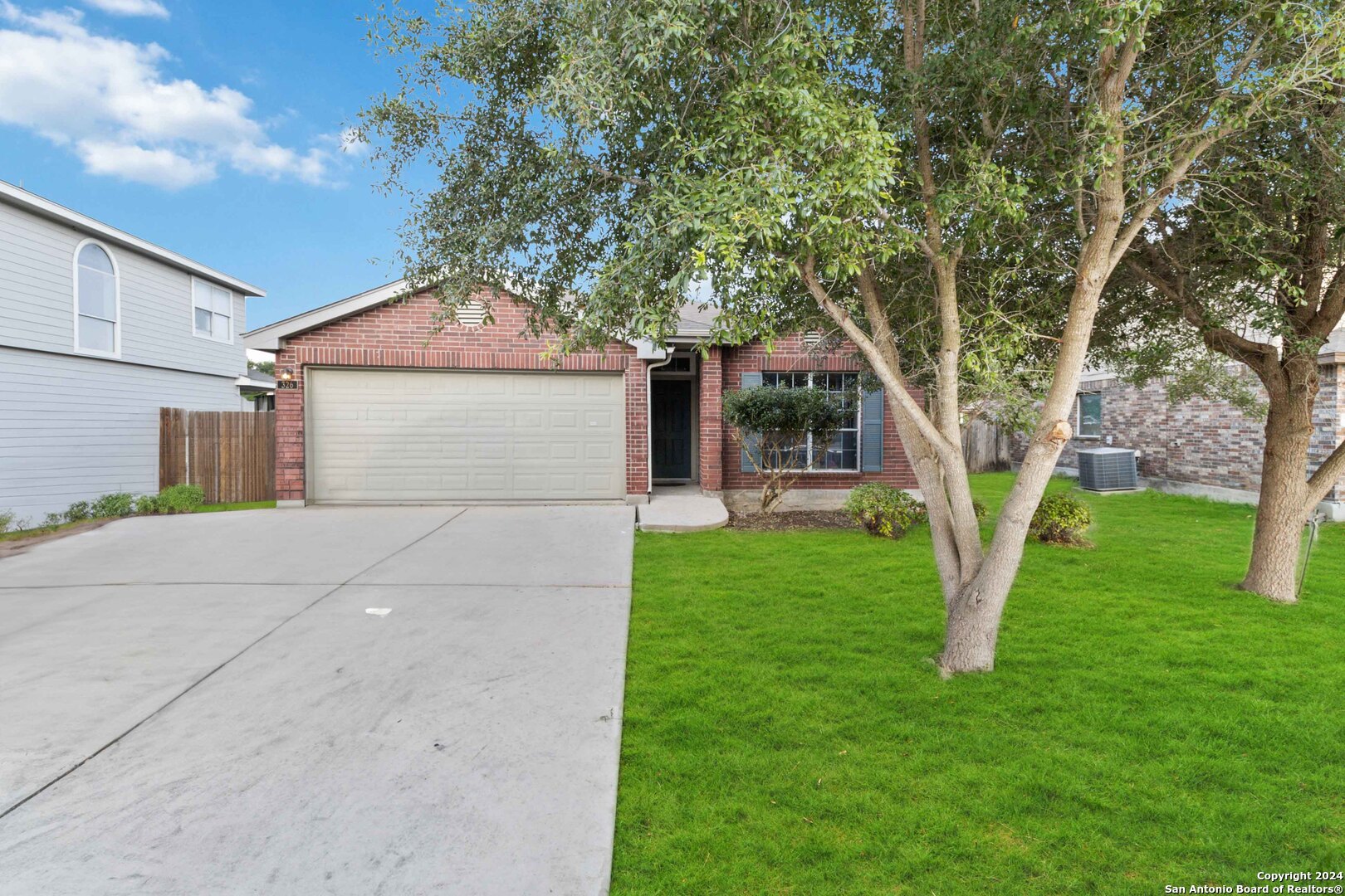 a front view of a house with a garden and yard