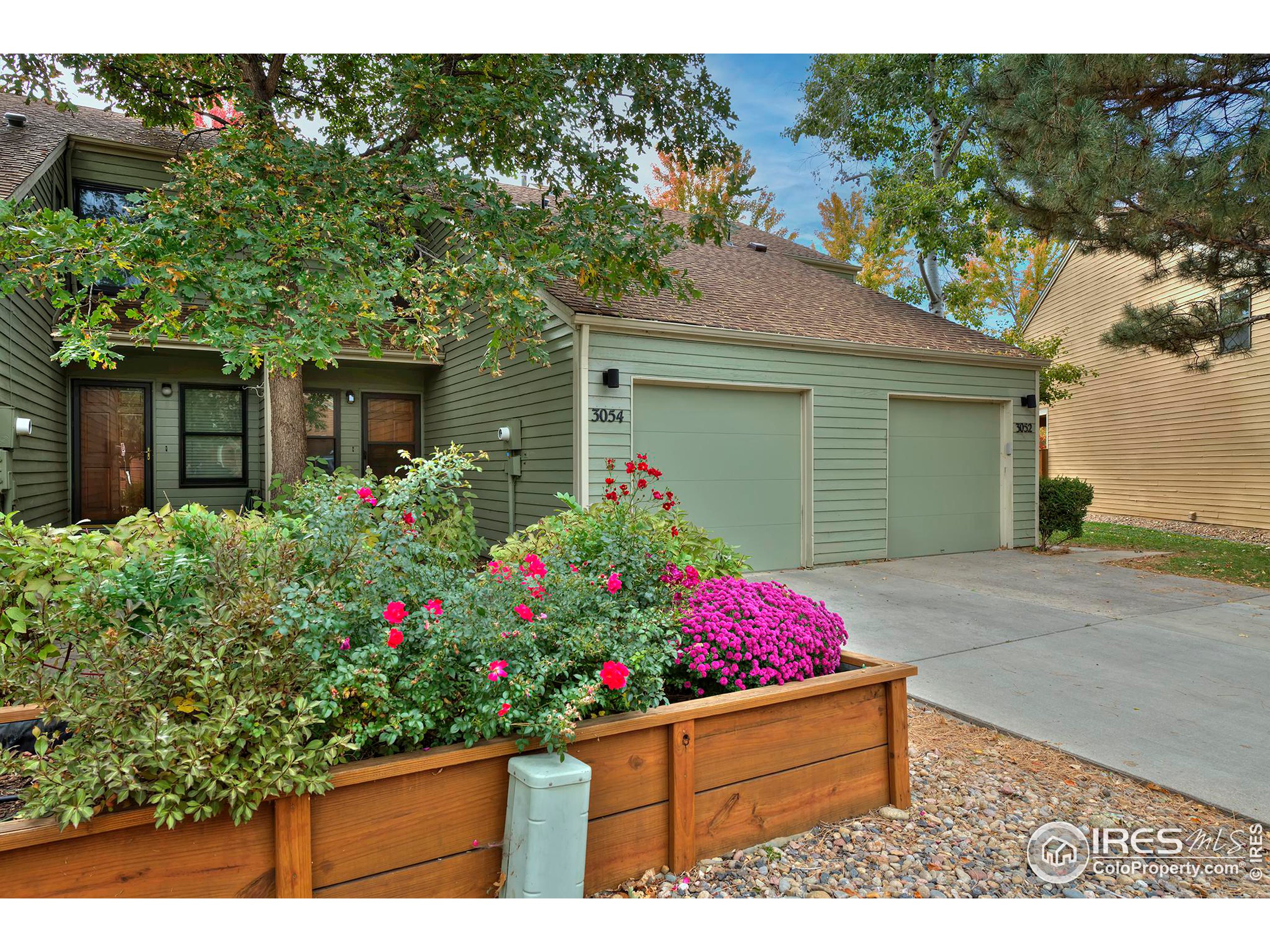 a view of a potted flower sitting in front of a house