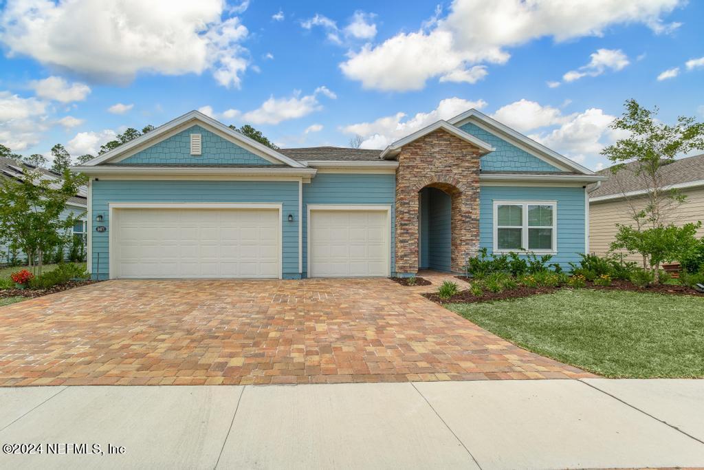 a front view of a house with yard and garage