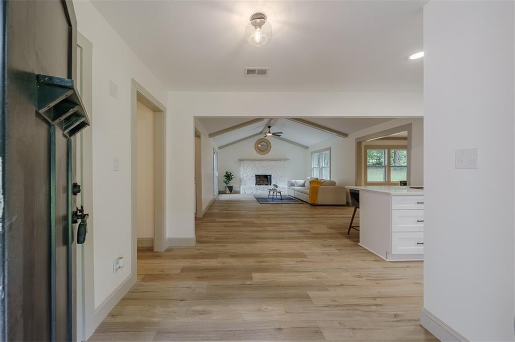 a view of a hallway view with wooden floor and furniture